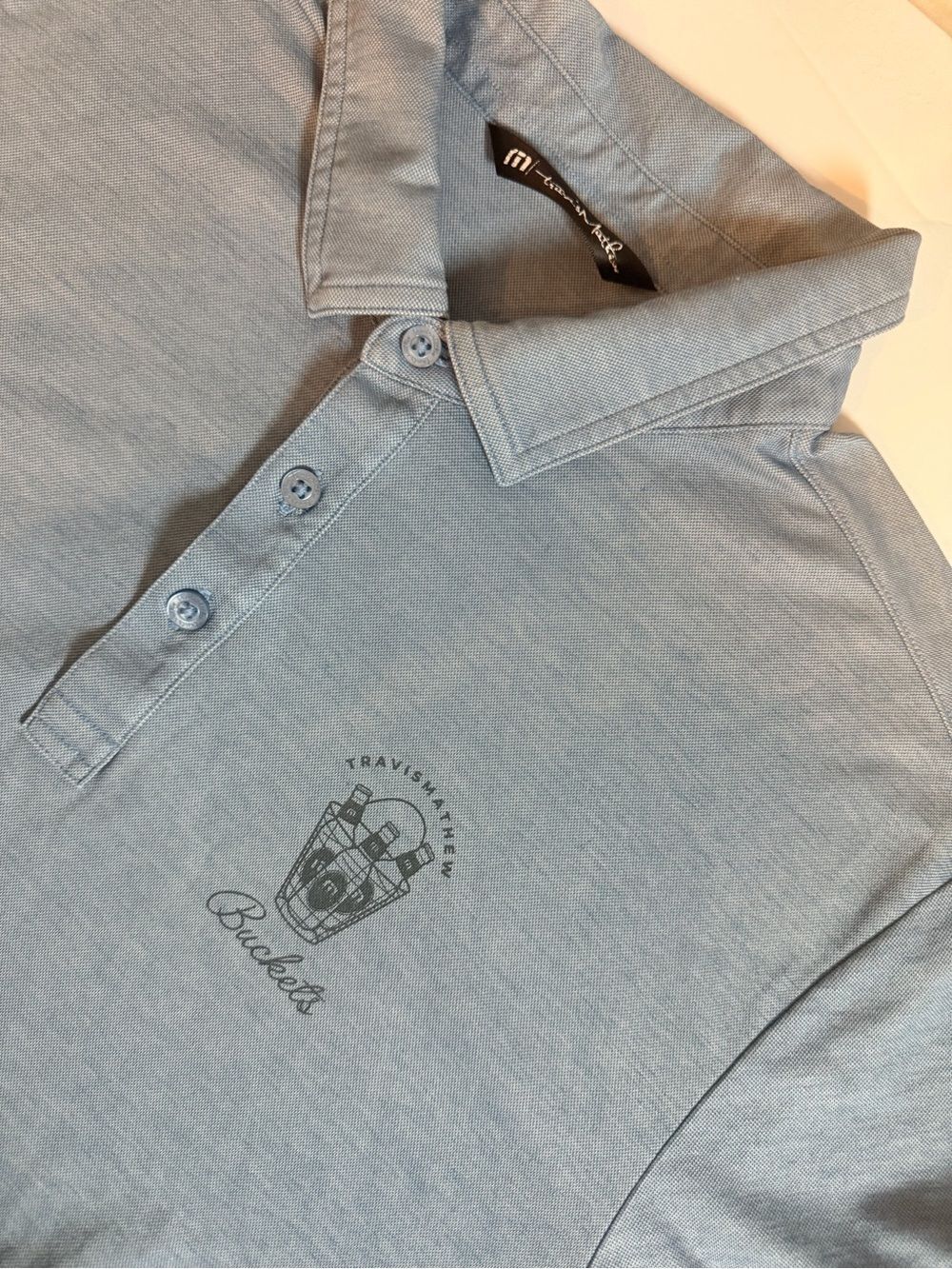 TravisMathew Buckets Golf Graphic Polo Shirt Size XL Light Blue Short Sleeve